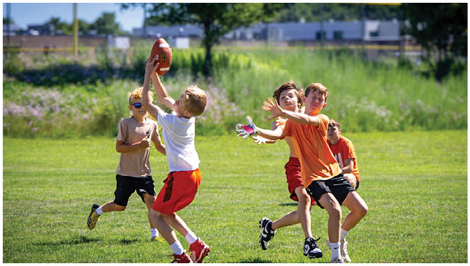 A group of football players on a field. Description generated by AI