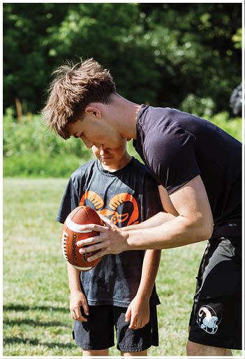 A football player running on the field. Description generated by AI