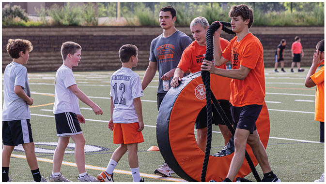 A group of football players on a field. Description generated by AI