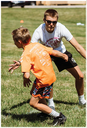 A football player running on the field. Description generated by AI