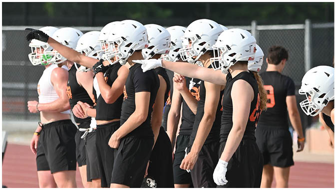 A group of football players on a field. Description generated by AI
