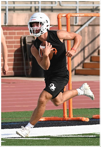 A football player running on the field. Description generated by AI