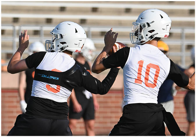 A group of football players wearing black and white uniforms. Description generated by AI
