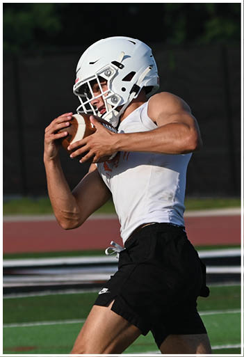 A football player running on the field. Description generated by AI