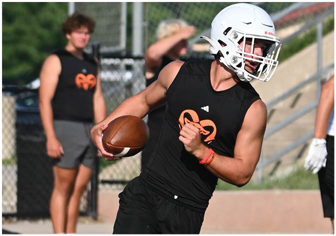 A group of football players wearing black and white uniforms. Description generated by AI