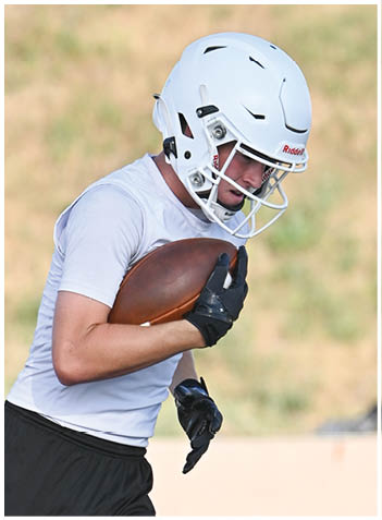 A football player wearing a blue jersey with the number 58 on it. Description generated by AI