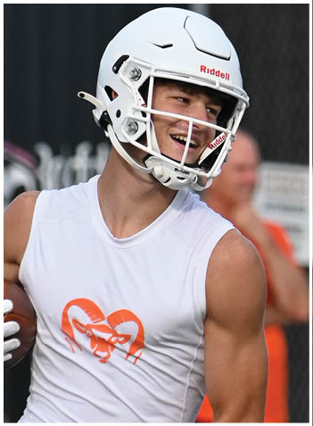 A football player wearing a blue jersey with the number 58 on it. Description generated by AI