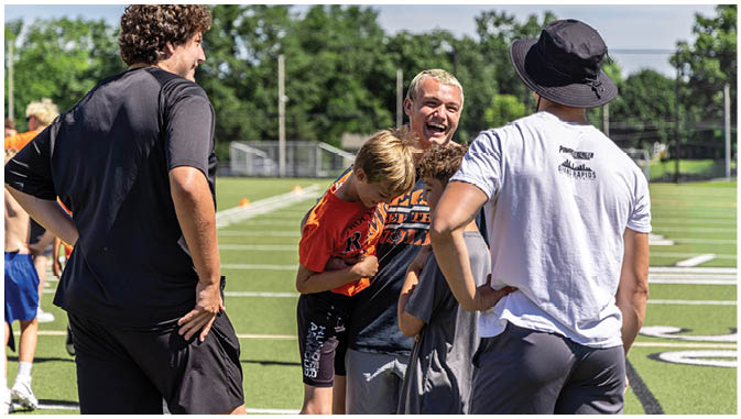 A group of football players on a field. Description generated by AI