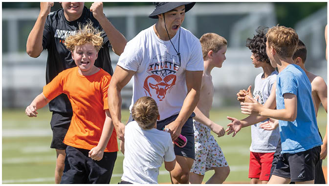 A group of football players on a field. Description generated by AI