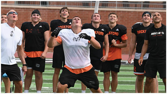 A group of football players on a field. Description generated by AI