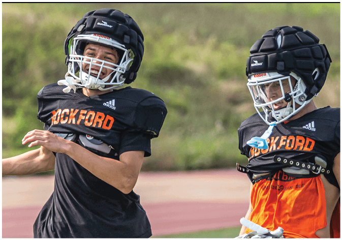 A group of football players wearing black and white uniforms. Description generated by AI