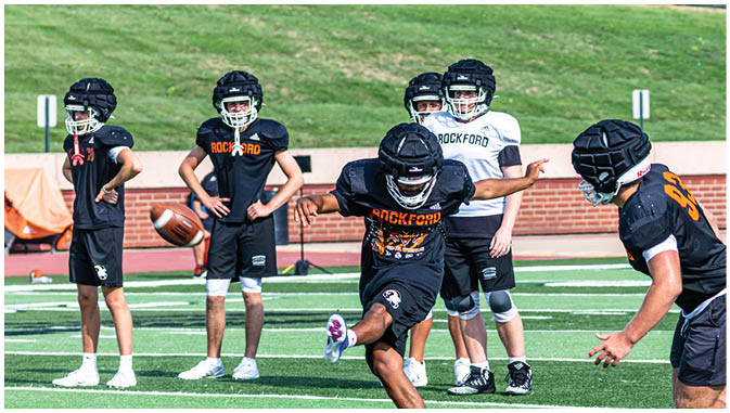 A group of football players on a field. Description generated by AI