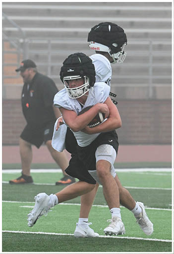 A football player running on the field. Description generated by AI