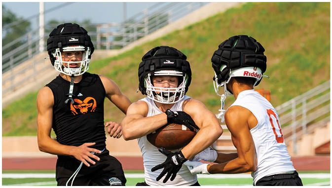 A group of football players on a field. Description generated by AI