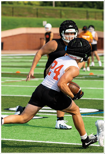 A football player running on the field. Description generated by AI