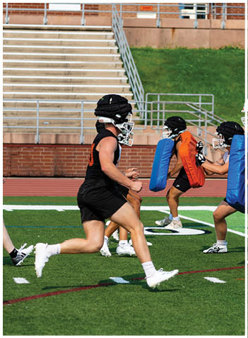 A football player wearing a blue jersey with the number 58 on it. Description generated by AI
