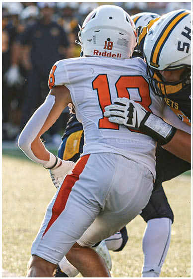 A football player wearing a blue and red jersey. Description generated by AI