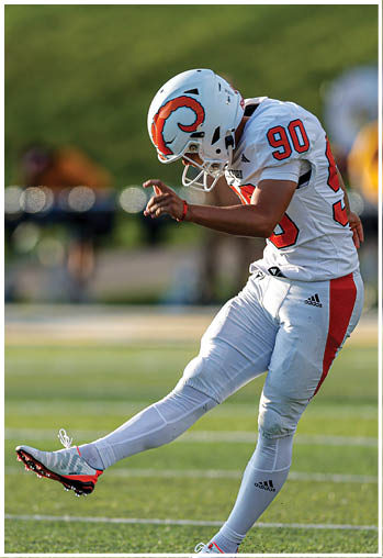 A group of football players celebrating a touchdown. Description generated by AI