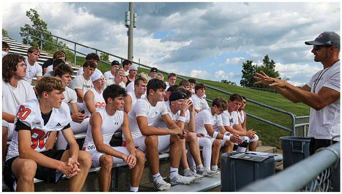 A group of football players on a field. Description generated by AI