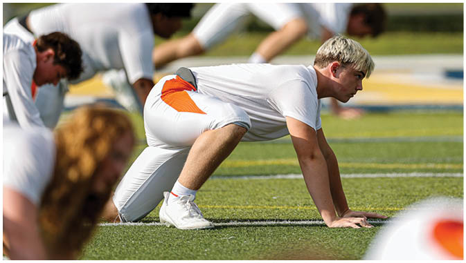 A group of football players on a field. Description generated by AI