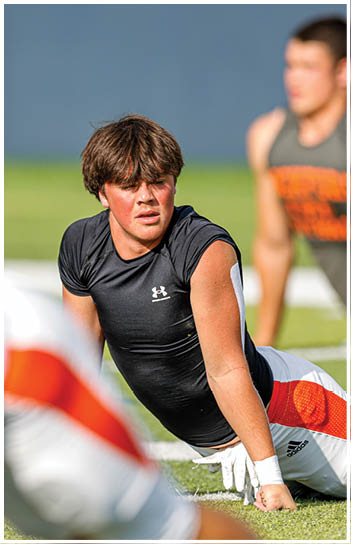 A football player running on the field. Description generated by AI