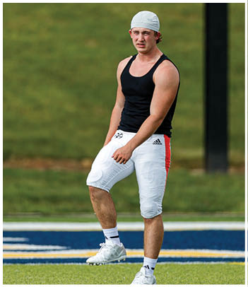 A football player wearing a blue jersey with the number 58 on it. Description generated by AI