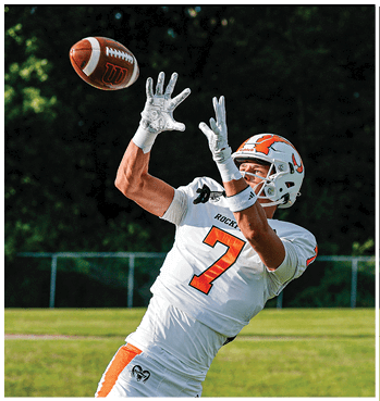 A group of football players celebrating a touchdown. Description generated by AI