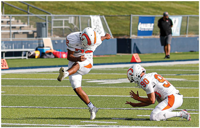 A group of football players wearing black and white uniforms. Description generated by AI