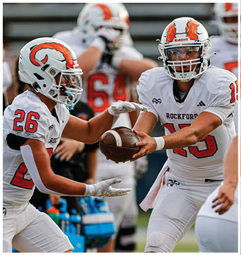 A group of football players celebrating a touchdown. Description generated by AI