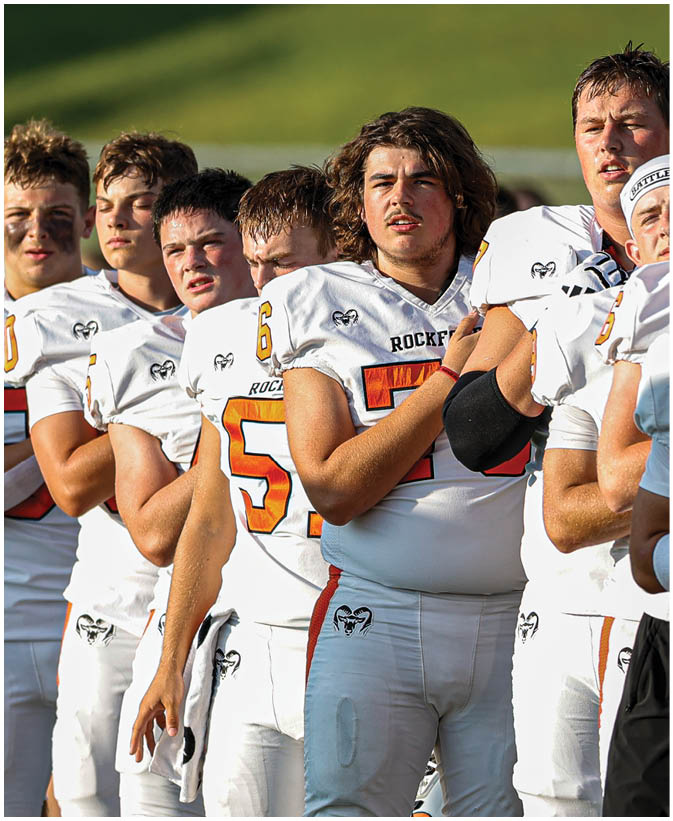 A group of football players on a field. Description generated by AI
