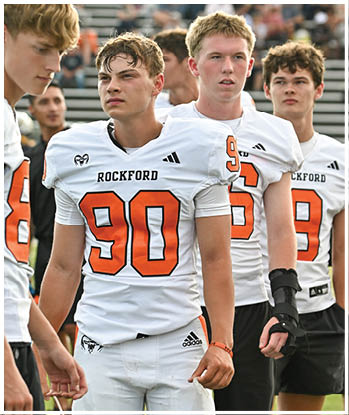 A group of football players celebrating a touchdown. Description generated by AI