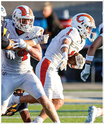 A group of football players celebrating a touchdown. Description generated by AI