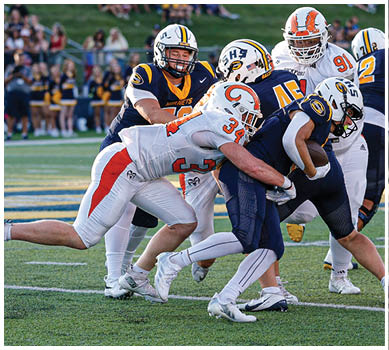 A football game is taking place with a group of men on the field. Description generated by AI