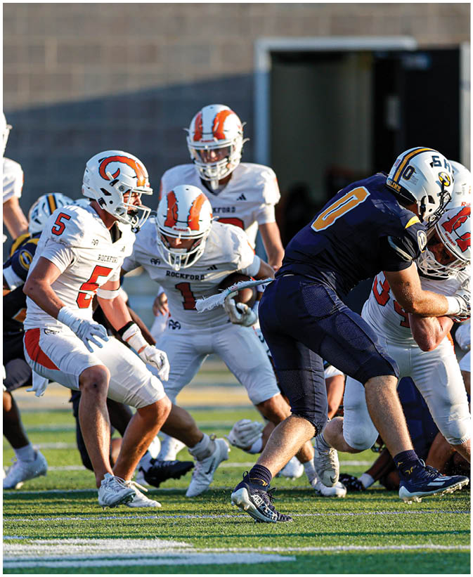 A group of football players on a field. Description generated by AI