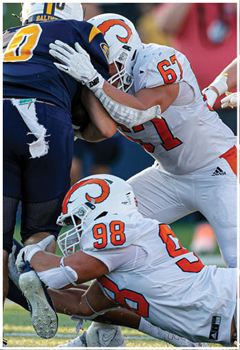 A group of football players celebrating a touchdown. Description generated by AI