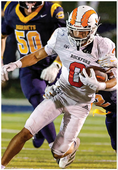 A football player wearing a blue and red jersey. Description generated by AI