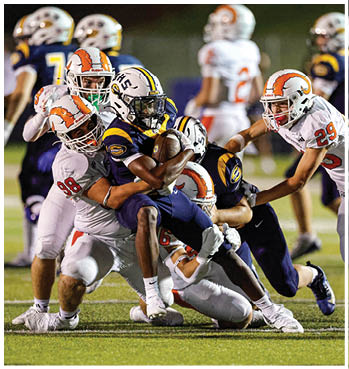 A group of football players celebrating a touchdown. Description generated by AI