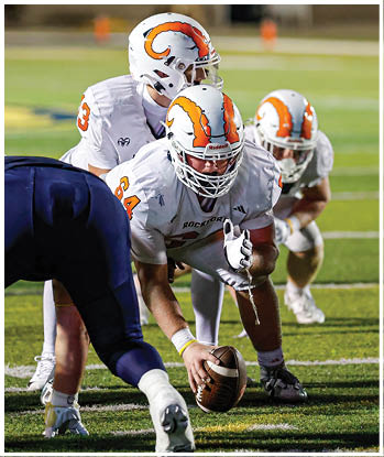A group of football players celebrating a touchdown. Description generated by AI