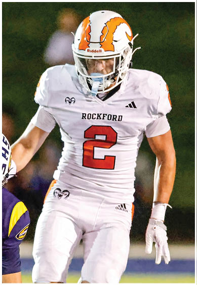 A football player wearing a blue and red jersey. Description generated by AI