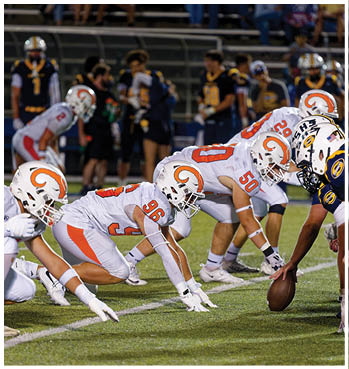 A group of football players celebrating a touchdown. Description generated by AI