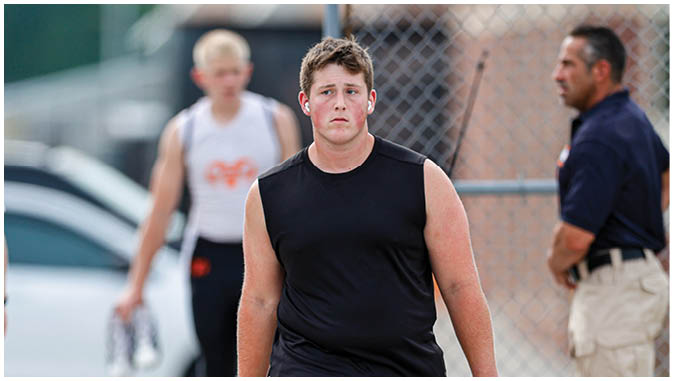A group of football players on a field. Description generated by AI