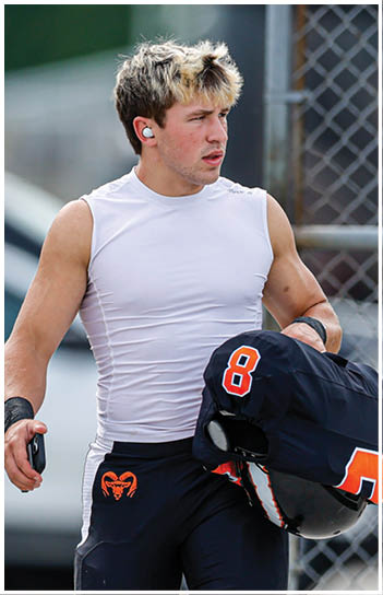 A football player running on the field. Description generated by AI