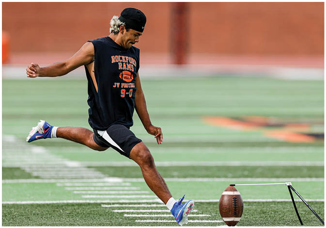 A group of football players wearing black and white uniforms. Description generated by AI