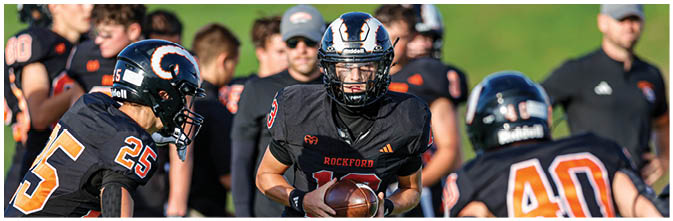 A group of football players on a field. Description generated by AI