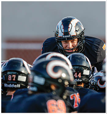 A group of football players celebrating a touchdown. Description generated by AI