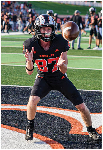 A group of football players celebrating a touchdown. Description generated by AI