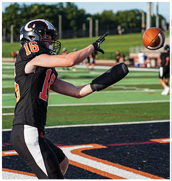 A group of football players celebrating a touchdown. Description generated by AI