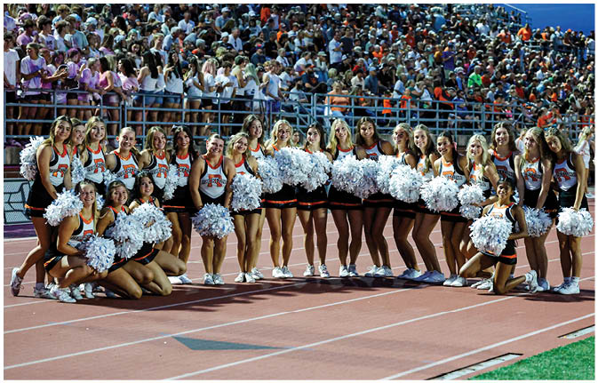 A group of football players wearing black and white uniforms. Description generated by AI