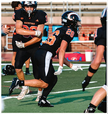 A group of football players celebrating a touchdown. Description generated by AI