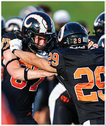 A group of football players celebrating a touchdown. Description generated by AI